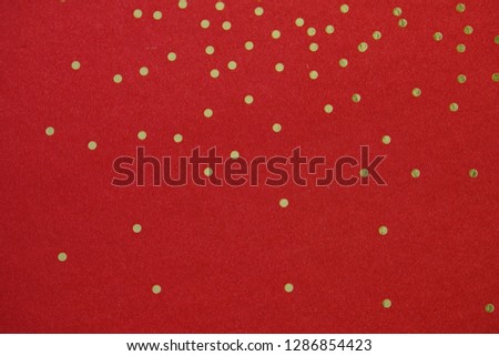 gold dots on red paper