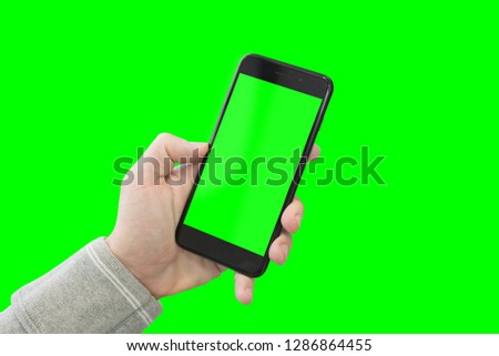 Modern smart phone ih man hand. Close-up. Isolated in green.