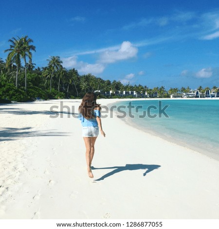 Girl running on Maldives beach. Take me to Paradise.