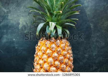 Pine apple tropical fruit on dark background. Raw eating concept Summer time. Season local super food product of Thailand. Flat lay top view