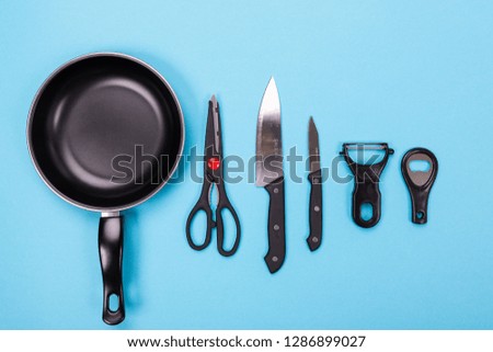 Close up picture of group of kitchen utensils with copyspace on blue background