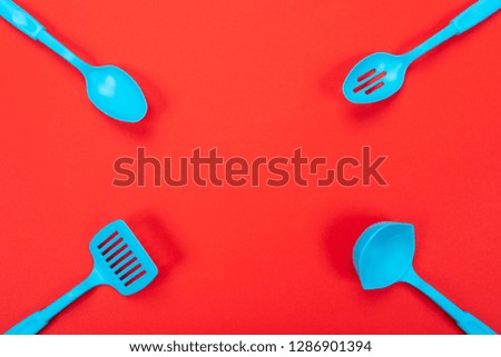 Close up picture of kitchen utensils with copyspace on red background