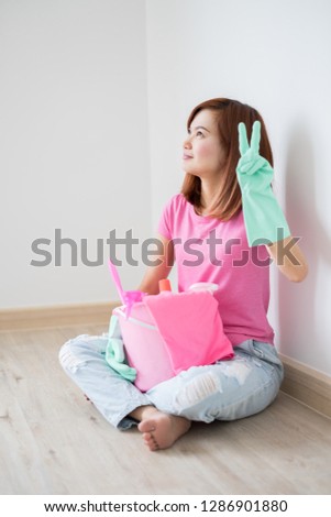 Cleaning concept. Asian woman with bucket of cleaning supplies