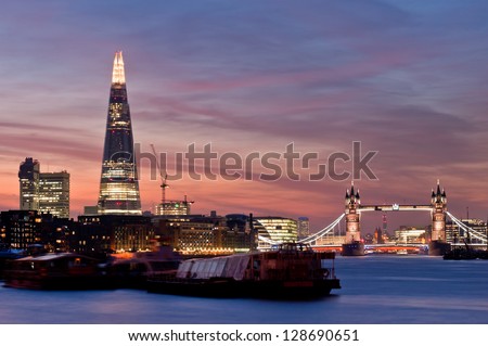 Sunset on the new London skyline with Tower Bridge and the new The Shard skyscraper. Long exposure.  Royalty-Free Stock Photo #128690651