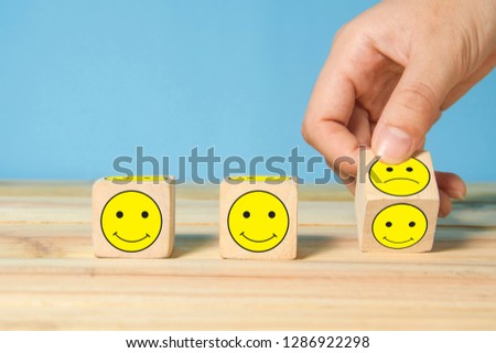 hand flipping unhappy turning to happy symbol, making customer good experience concept Royalty-Free Stock Photo #1286922298