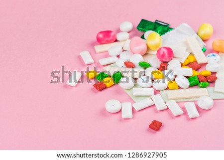 Assortment of bubble gum on pink background on pink backgrouond. Copy space