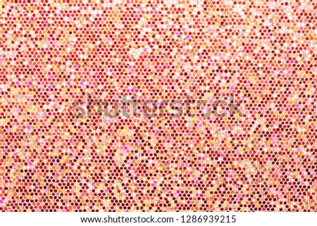 Red orange background. Abstraction shiny sequins. Sequins texture closeup macro.