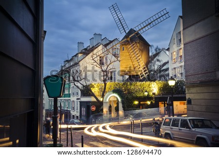 An old mill called Moulin de la Galette in Montmartre, the neighborhood in Paris, France. where famous painters like Picasso or Modigliani used to live. Royalty-Free Stock Photo #128694470