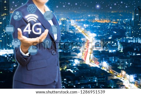 Business people showing 4g wireless and icon on city at the night time background