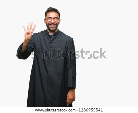 Adult hispanic catholic priest man over isolated background showing and pointing up with fingers number four while smiling confident and happy.