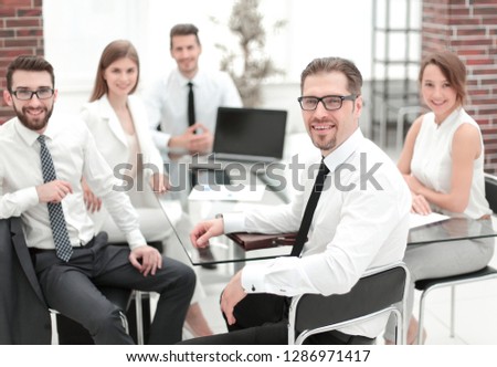 boss and business team sitting at their Desk