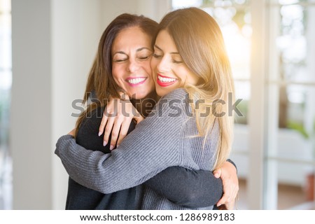 Beautiful family of mother and daughter together, hugging and kissing at home Royalty-Free Stock Photo #1286989183