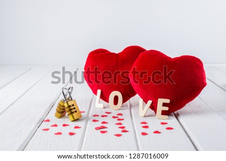 Valentines Day background with Red Heart shape, Wooden letters word "LOVE" and Couple Combination golden padlock on white wooden table and copy space for your graphic.