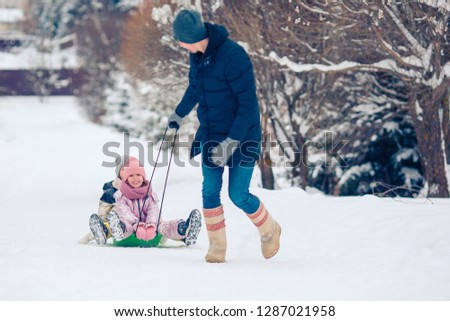 Happy family having fun outdoors in winter day