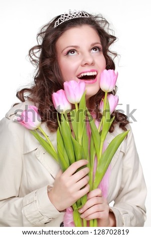 Happy girl with bouquet of spring flowers