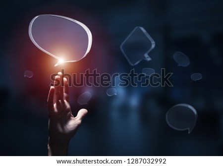 Close of businessman hands touching glass speech bubble as internet concept. Mixed media