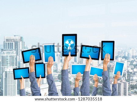 Set of tablets in male hands against modern cityscape background