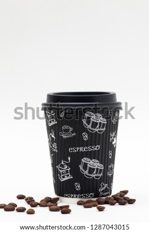 Corrugated paper cup for coffee with a black lid and scattered coffee beans on a white background. Takeaway drink container. Template of drink cup for your design. Can put text, image, and logo
