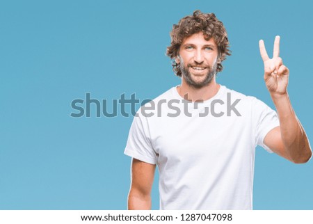Handsome hispanic model man over isolated background showing and pointing up with fingers number two while smiling confident and happy.