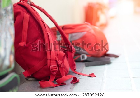 Back to school background concept. Student backpacks of children lay down on the floor at hallway corridor in front of classroom on start of semester day. Royalty-Free Stock Photo #1287052126
