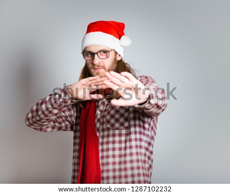 handsome man shows stop, with long hair, isolated closeup