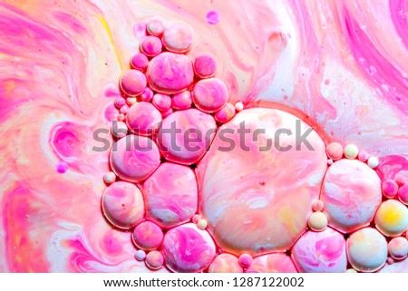 Macro photography of colorful bubbles on some fluids that seems to be some kind of unknown worlds.