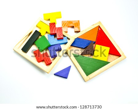 colorful wooden toy puzzle in red, yellow, green and blue, isolated on white.