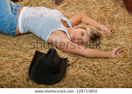 Girl resting on hay