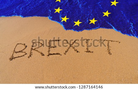 Handwrite text Brexit on sand coastline and wave with EU flag pattern. On referendum, voted to exit United Kingdom from EU knows as Brexit, which is expected on March 29, 2019 Royalty-Free Stock Photo #1287164146