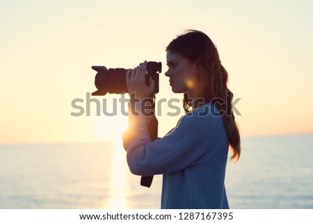 Woman photographer outdoors with a camera
