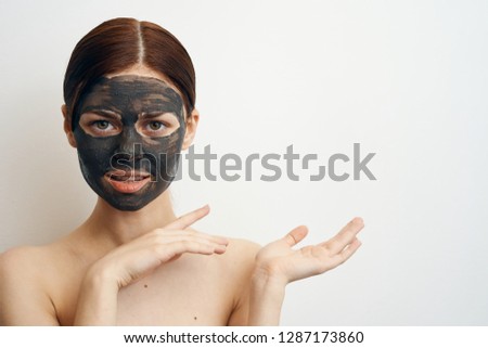 woman in a cosmetic mask on her hand place free on white isolated background