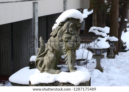 Amazing stone foo or fu dogs in the snow from japan