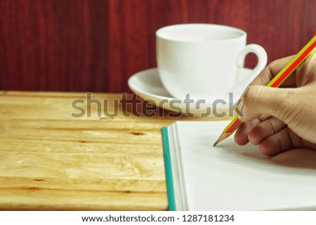 People writing on notebook and work  on wooden table - Image Royalty-Free Stock Photo #1287181234