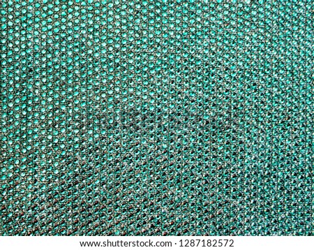 The texture of the knitted fabric, covered with small rhinestones. Thin yarn turquoise color. For textures, backgrounds. Royalty-Free Stock Photo #1287182572