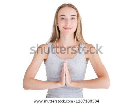 Close-up of hands of white woman in white clothes meditating indoors, focus on arms in Namaste gesture. Healthy lifestyle concept. Mock up. Copy space. Template. Blank.