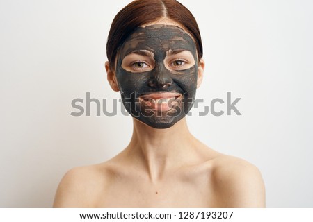 smile spa facial woman in cosmetic mask