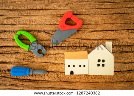 House and wrench and craftsman tool and saw model put on the wooden vintage background, Construction real estate and renovate of home concept
