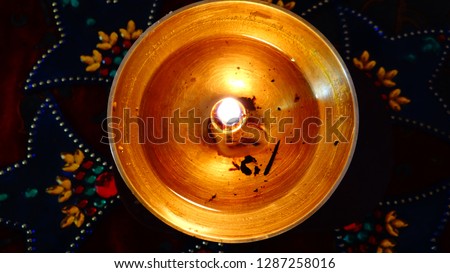 Lighting an lamp in front of the God 