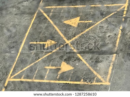 Yellow arrows in a parking lot