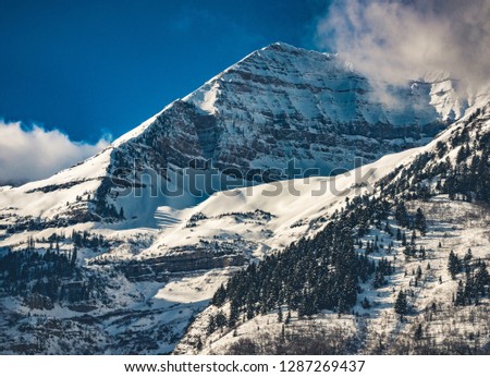 Clouds move over the dramatic snow capped peaks of Mount Timpanogos after a winter snowstorm clears the Wasatch Mountain Range near Sundance in Provo Canyon, Utah, USA.