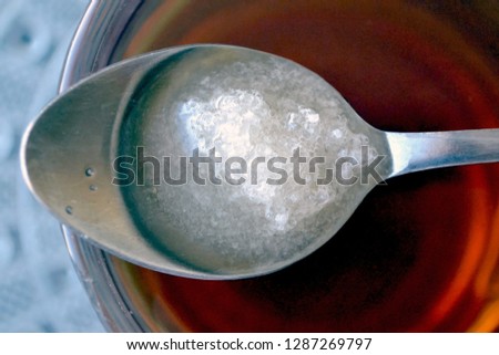 Sugar is dissolved in a teaspoon
