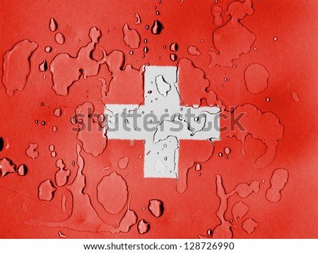 The Swiss flag  covered with water drops