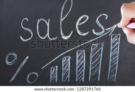 woman hand with sales word on chalkboard