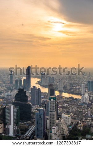 Bangkok Metropolis, aerial view over the biggest city in Thailand. Bangkok sky line with huge park before sunset.