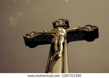 Jesus Christ hang on the cross against dark sky