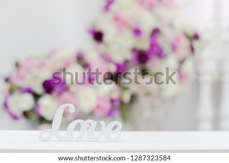 inscription love on a background of flowers. Free space. Copy space.
