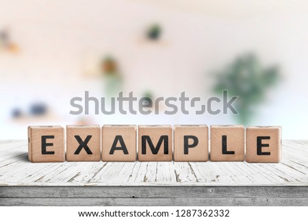 Example sign on a wooden table in a bright room with a colorful pattern in the background