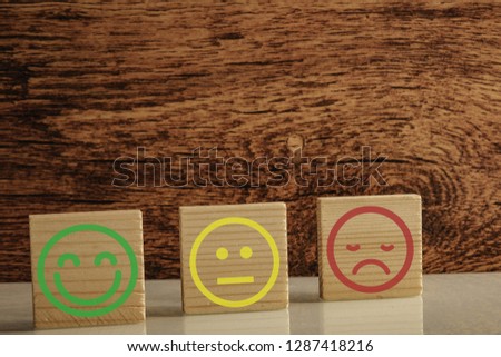 three different happy face paper clip isolated with black background.