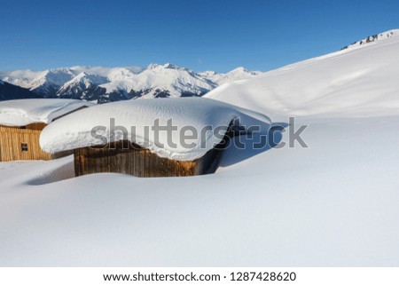 snow-covered ski hut in the austrian alps