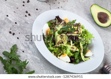 Close up view on salad with quinoa, avocado and egg on a concrete background. Healthy food. Spanish cuisine. free copy space for text, logo. Picture for recipe. Flat lay lunch. 